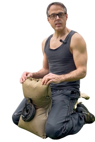 MiniWorkoutDad kneeling with GripSack sandbag